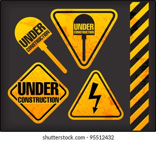 Under construction. Grunge signs with the lighting and spade