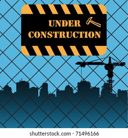 Under construction plate on a fence made from wire