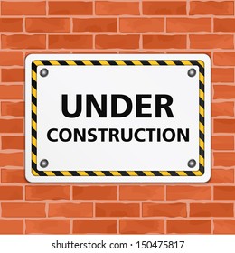 Under construction sign on brick wall, vector eps10 illustration