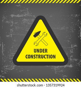 Under construction sign on gray ground background. Vector illustration for website. Under construction triangle with black and yellow striped borders vector illustration. Under construction triangle 
