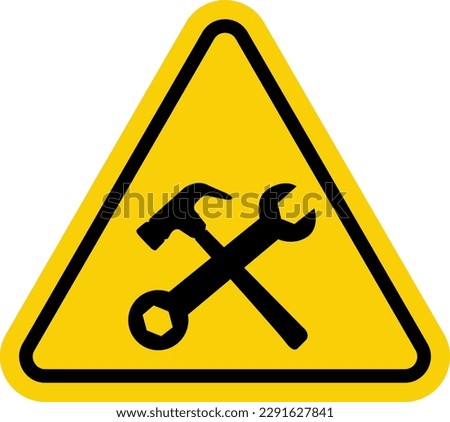 Under construction sign. Under construction warning sign. Yellow triangle sign with a crossed hammer and a wrench icon inside. Be careful at construction site. Repair work. Cars. Workshop. Machine.