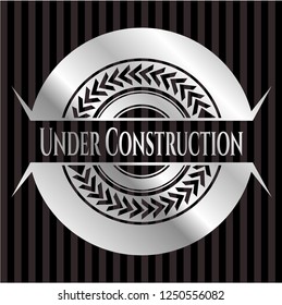 Under Construction silver emblem or badge