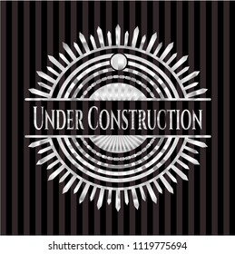 Under Construction silvery emblem or badge