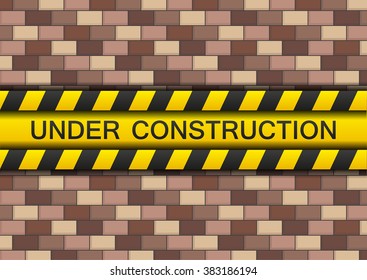 Under construction yellow tape on brown-red brickwall