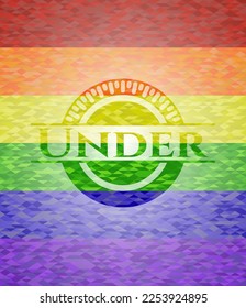 Debajo del emblema sobre fondo de mosaico con los colores de la bandera LGBT. 