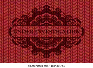 Under Investigation text inside Red woolen fabric emblem. Cloth fashionable background. Vector illustration. 