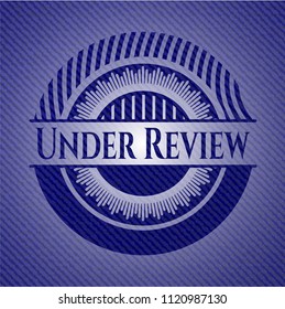 Under Review emblem with jean texture