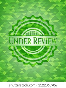 Under Review green emblem with triangle mosaic background