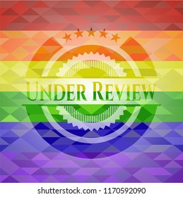 Under Review on mosaic background with the colors of the LGBT flag