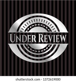 Under Review silver emblem