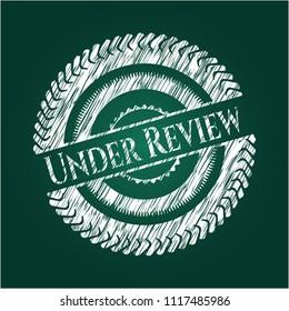 Under Review written with chalkboard texture