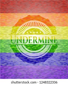 Undermine emblem on mosaic background with the colors of the LGBT flag