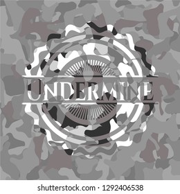 Undermine on grey camouflaged texture