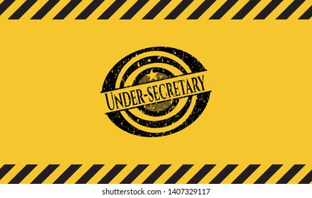 Under-secretary black grunge emblem inside yellow warning sign. Vector Illustration. Detailed.