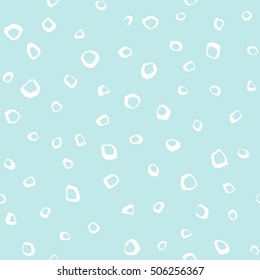 Uneven specks, spots, blobs, splashes seamless pattern. Free hand drawn speckles, flecks, stains or dots of different size texture. Abstract winter background. Light pastel colors.