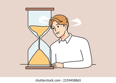 Unhappy bored man look at hourglass tired of long waiting. Upset sad male observe sandglass checking time counting minutes. Boredom and anticipation. Flat vector illustration. 