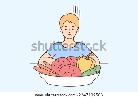 Unhappy boy child sit at table near plate with vegetables. Upset small kid refuse eating healthy veggies. Nutrition, diet and children. Vector illustration. 
