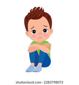 unhappy boy sitting with hands on knees
