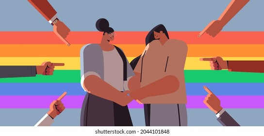 unhappy lesbian couple surrounded by hands fingers mocking discrimination transgender love LGBT community