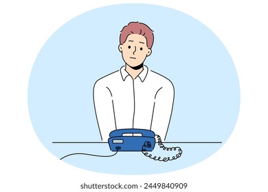 Unhappy man sit at desk look at landline phone waiting for someone call. Frustrated guy awaiting ring looking at corded telephone. Vector illustration.