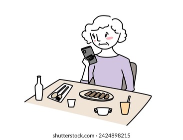 Unhappy mature woman using phone while having meal at restaurant. Melancholy senior woman using phone online at café while she eating her lunch. Unhappy woman sitting at dining table and texting. 