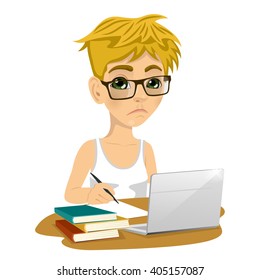 Unhappy teenage schoolboy with glasses doing his homework with laptop and books on desk