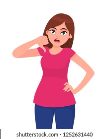 Unhappy woman showing or gesturing thumb down sign. Girl doing a negative gesture, looking with negative expression and disapproval. Bad, dislike, disapprove, disagree concept illustration in vector.