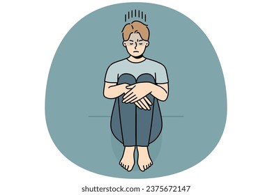 Unhappy young man sitting on floor suffer from loneliness or depression. Upset sad guy struggle from solitude or bad mood. Vector illustration.