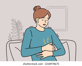 Unhealthy woman sit on couch suffer from stomachache. Unwell female struggle with abdominal pain or cramps. Healthcare. Vector illustration. 