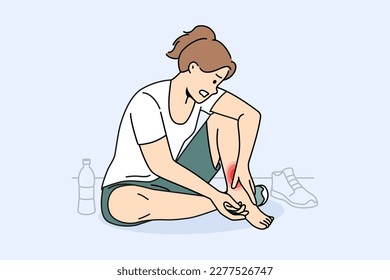 Unhealthy woman sit on floor in gym touch hurt ankle. Unwell girl suffer from trauma or injury exercising or doing sports. Vector illustration. 