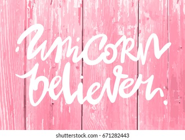 Unique hand drawn lettering quote about unicorns - unicorn believer-with wood texture background