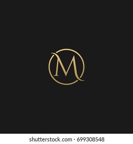 Unique modern creative elegant circular shaped fashion brands black and gold color M initial based letter icon logo.