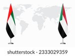 United Arab Emirates and Sudan flags for official meeting against background of world map.