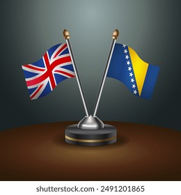 Banderas de mesa del Reino Unido y Bosnia y Herzegovina en relación con el fondo de gradiente