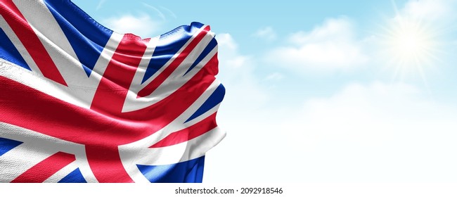 United Kingdom flag in the blue sky. Horizontal panoramic banner.