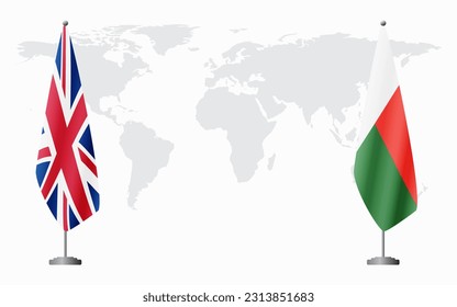 United Kingdom and Madagascar flags for official meeting against background of world map.