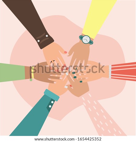 Unity, hands of diverse group of people putting together, teamwork.