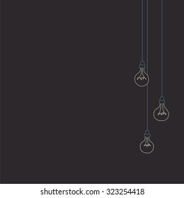 Unlit lightbulbs dangling on their cords