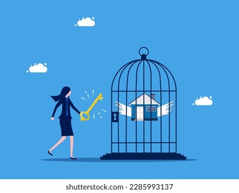 Unlock the value of the asset. Businesswoman uses a key to unlock a house from a birdcage. business and investment concept