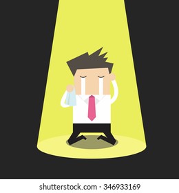 Unlucky businessman crying alone in spotlight