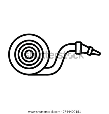 Unspooled flexible hose extending from coiled reel for industrial applications