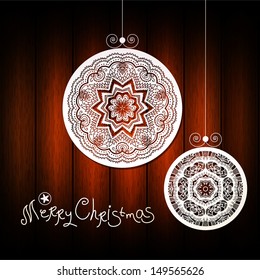 Unusual abstract vector christmas background. Vector wood background with "Merry Christmas" lettering. White floral ornaments look like lace or doily. Vector illustration. Xmas design element.
