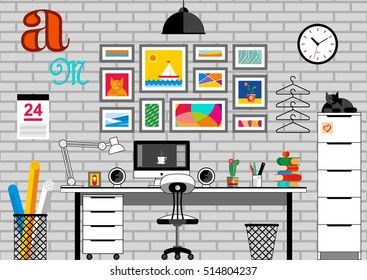 Unusual, interesting, bright workspace with computer, colorful books, a flowering cactus and a lamp on the table