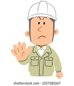 The upper body of a young man wearing work clothes and a helmet showing a gesture of refusal