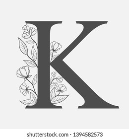 Uppercase Letter K with flowers and branches. Vector flowered monogram or logo. Hand Drawn concept. Botanical design branding. Composition of letter and flowers for wedding card, invitations, brand.