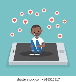 Upset crying black character sitting on the mobile's screen and hugging his knees surrounded by the dislike symbols / editable flat vector illustration, clip art