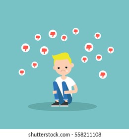 Upset crying boy sitting and hugging his knees surrounded by the dislike symbols / editable flat vector illustration, clip art