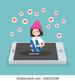 Upset crying girl sitting on the mobile's screen and hugging her knees surrounded by the dislike symbols / editable flat vector illustration, clip art