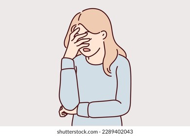 Upset girl covers face with hand due to stress and lack of strength to solve problems. Woman doing facepalm gesture feeling stressed and depressed or frustrated after another failure 