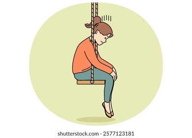 Upset little girl sits on swing with head down after parents divorce or reprimand at school. Upset schoolgirl is sad because of problems with friends who do not want to go out together